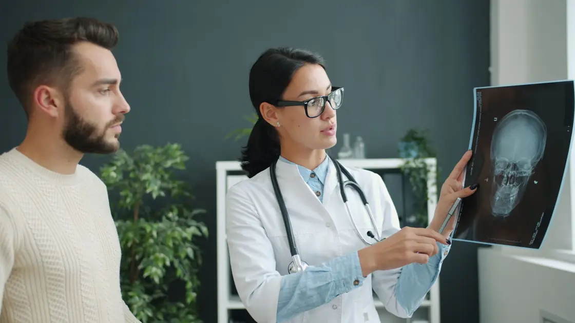 A clinician explaining a scan result to a patient in a consulting room