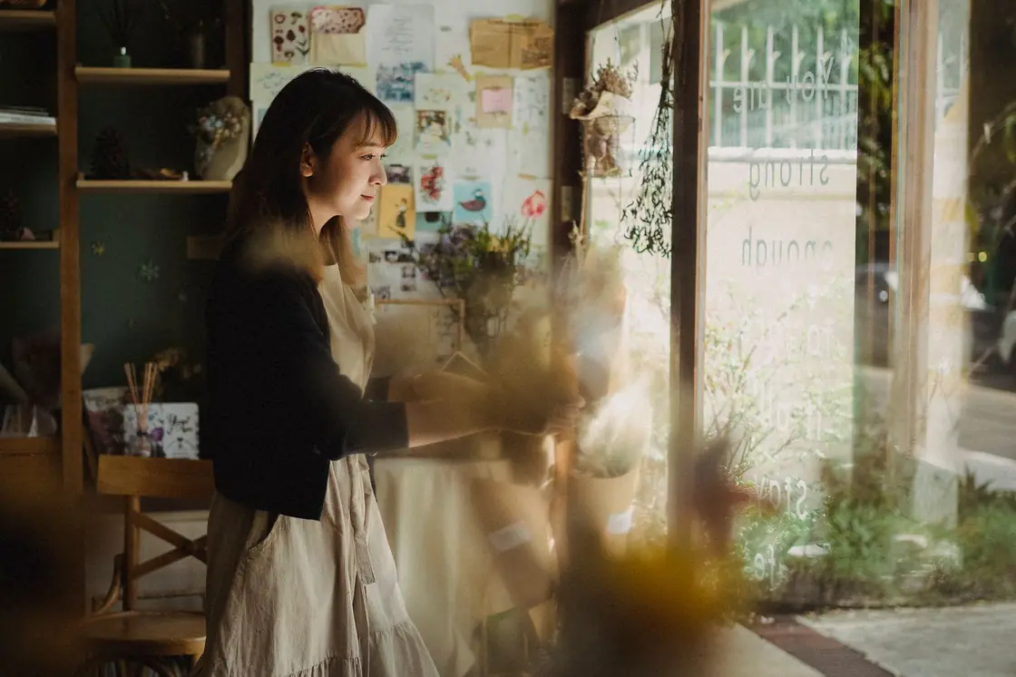 A small business owner setting up their workspace at the start of the day